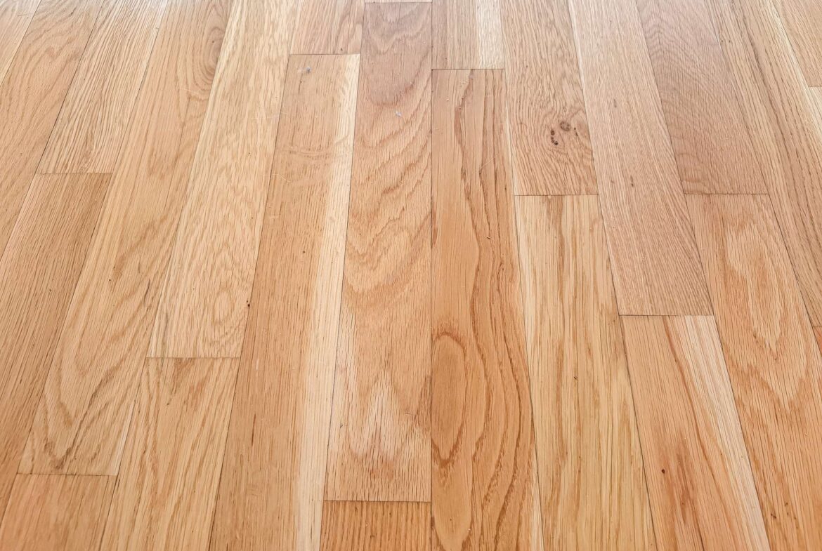 Light brown hardwood floor with rectangular planks and natural wood grain patterns across the surface.