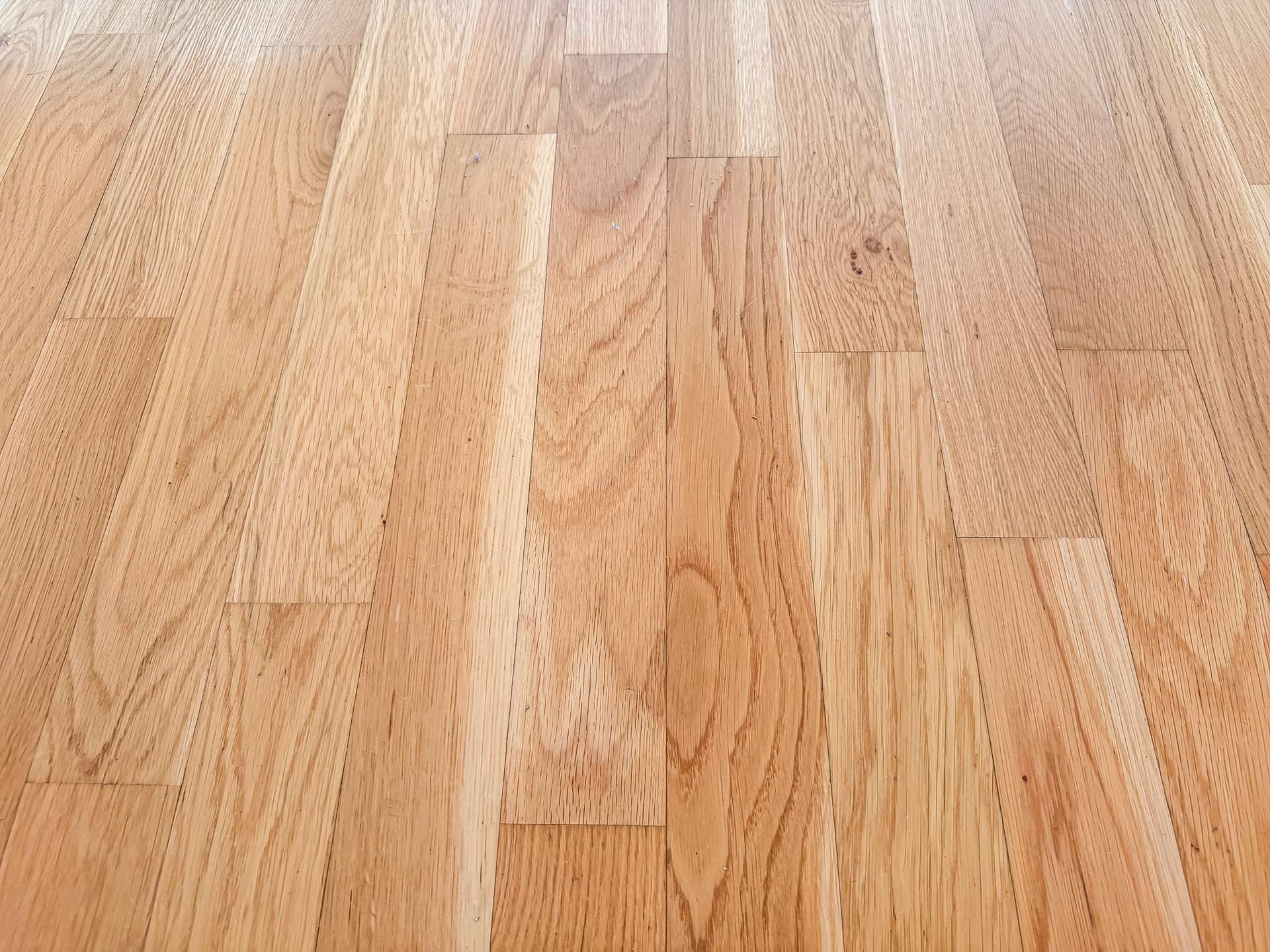 Light brown hardwood floor with rectangular planks and natural wood grain patterns across the surface.