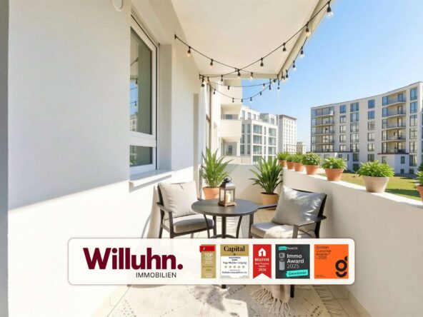 Sunny apartment balcony with a small table, two chairs, string lights, and potted plants; a Willuhn Immobilien banner is visible.