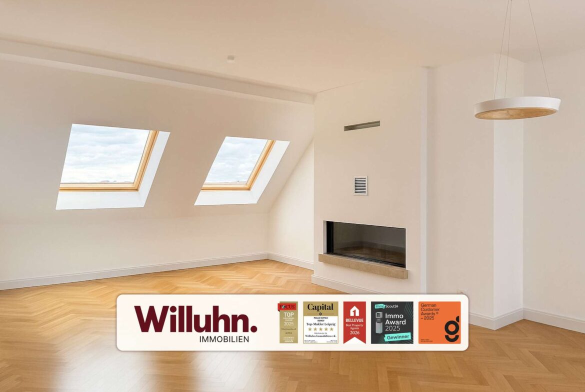 Bright empty living room with two skylights, warm hardwood floor, and a modern built-in fireplace.