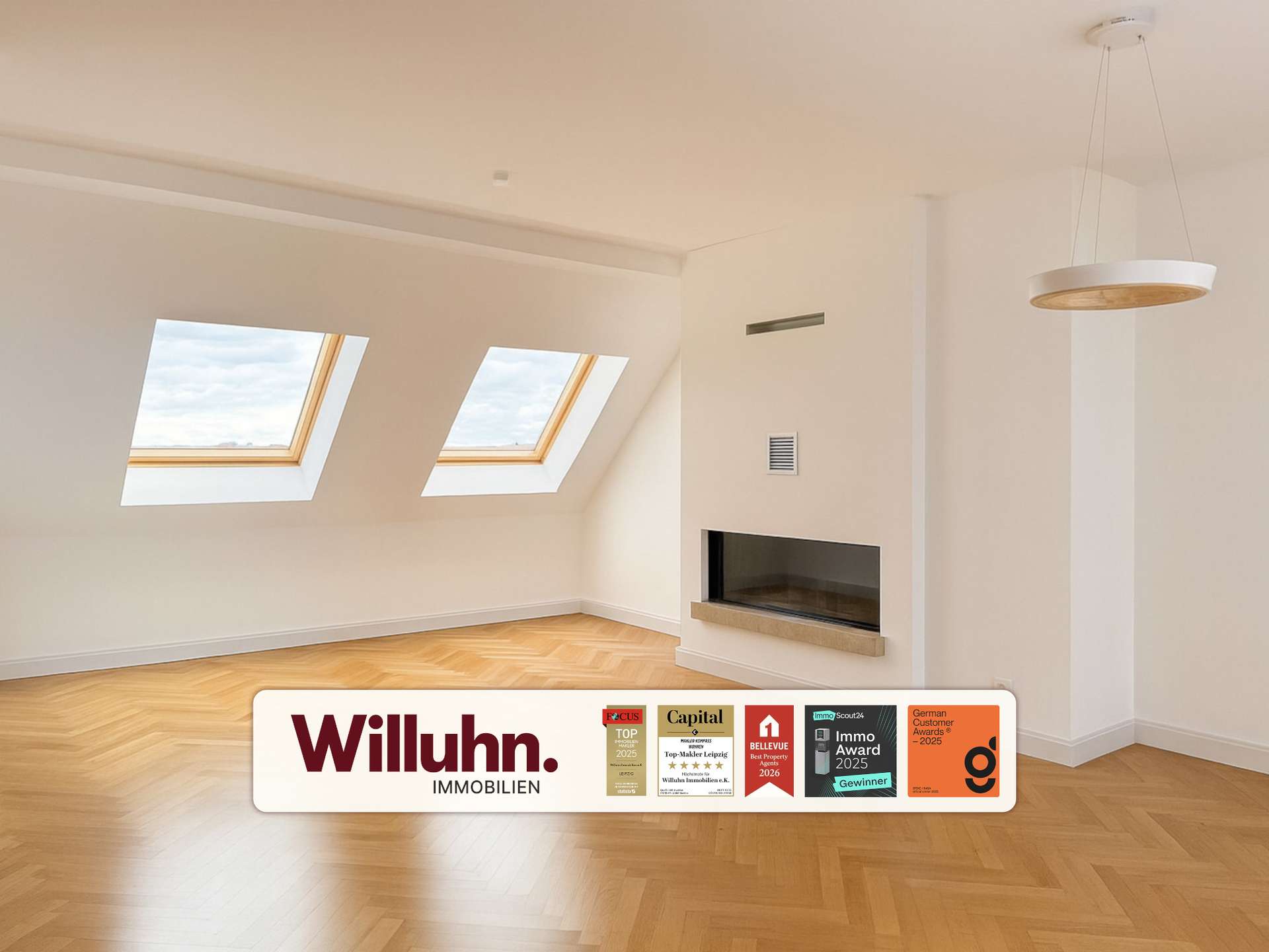 Bright empty living room with two skylights, warm hardwood floor, and a modern built-in fireplace.