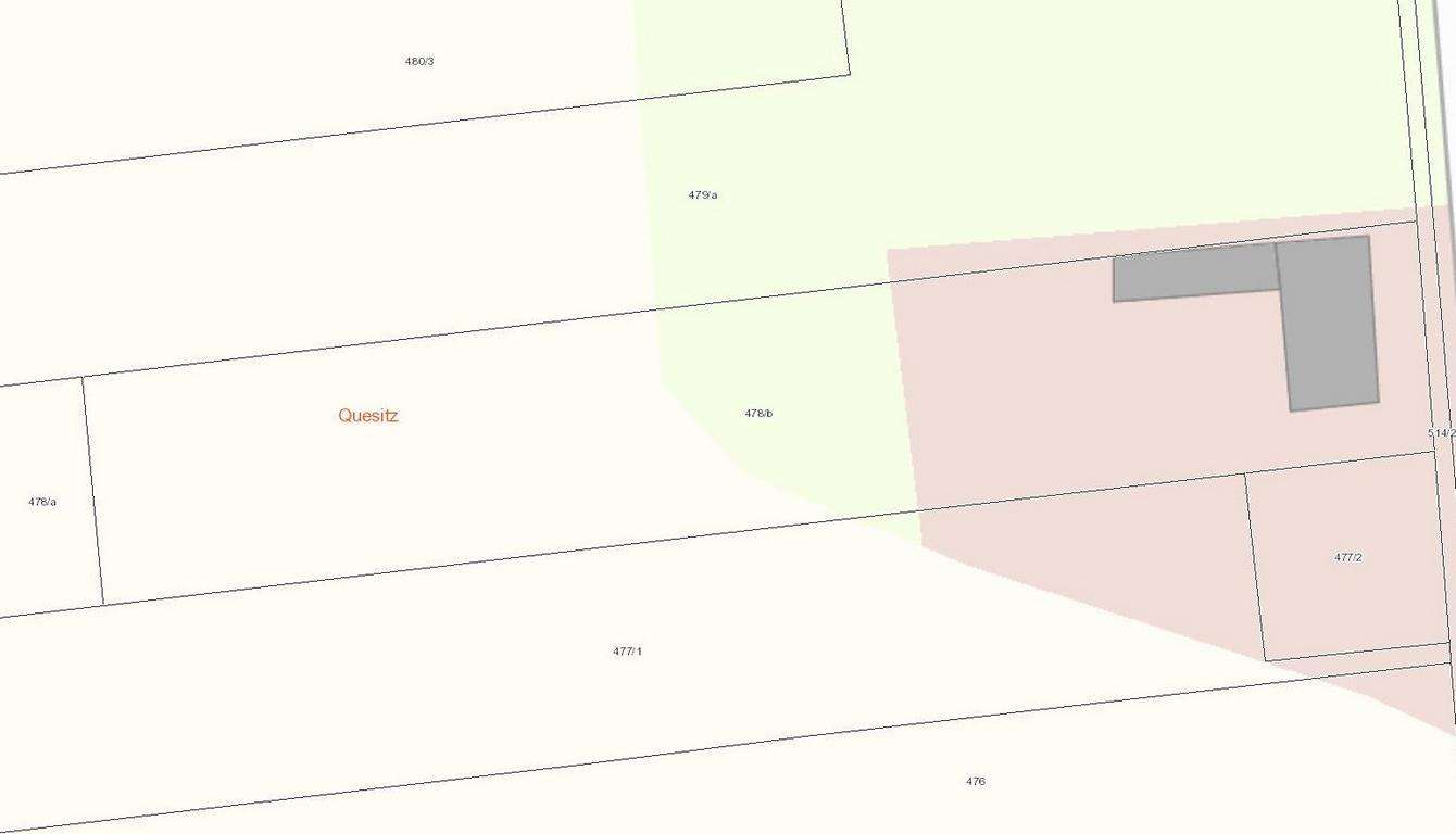 Cadastral map of property parcels with boundary lines; a light green area and a pink area indicating different land uses, plus a gray building footprint on the right side.