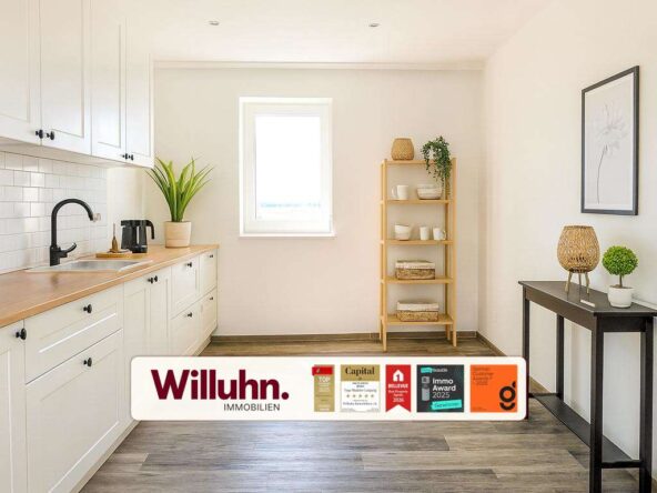 Bright modern kitchen with white cabinets, wooden counter, black faucet, and a potted plant under a window