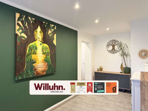 Interior showroom with a large forest-themed painting on a dark green wall above a light-colored floor and counter area.