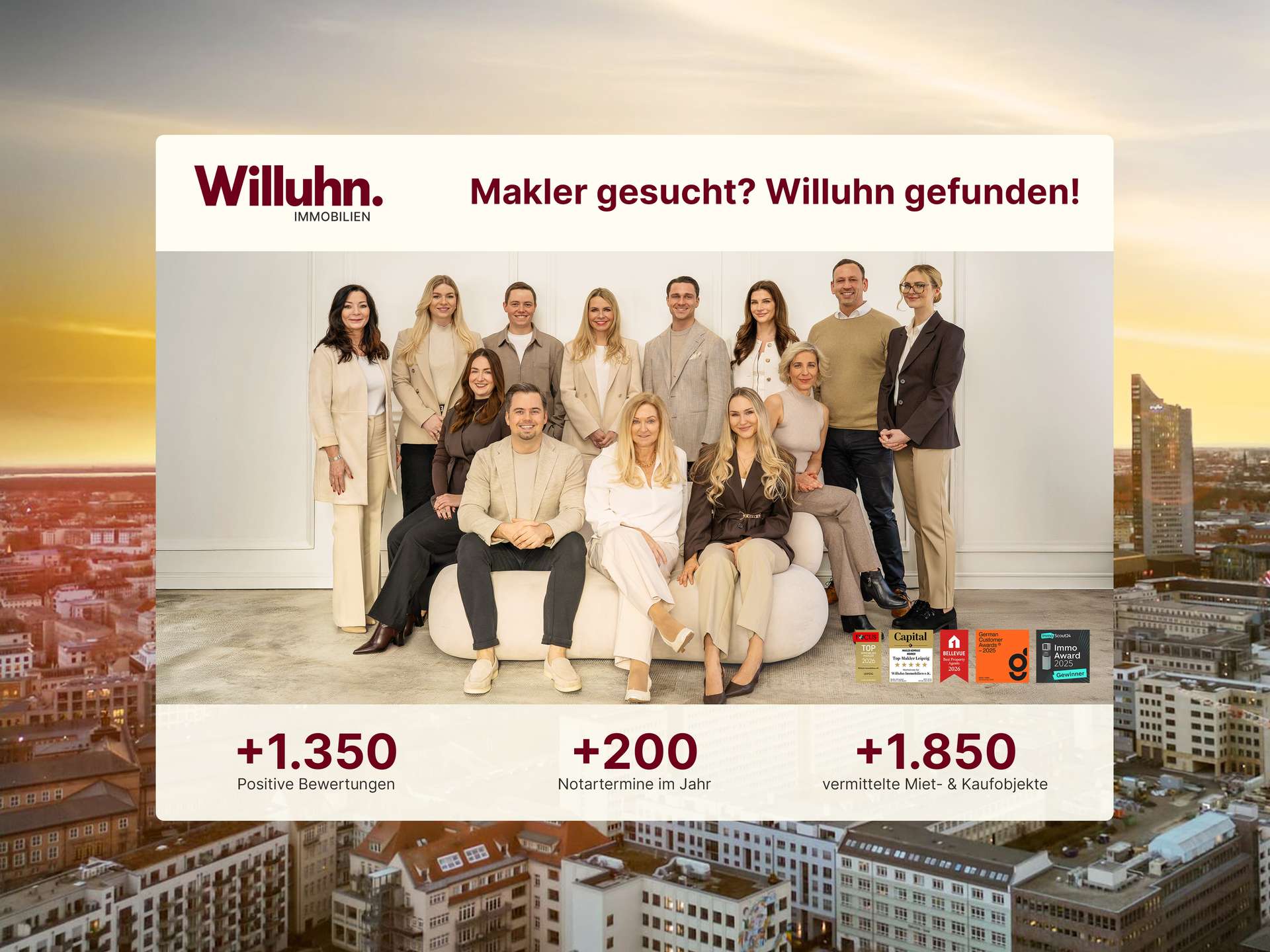 Group of Willuhn Immobilien agents posing in a bright office under a banner that reads 'Makler gesucht? Willuhn gefunden!'