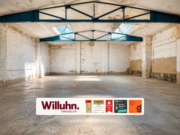 Empty industrial warehouse interior with white brick walls, blue steel trusses, and skylights; a Willuhn Immobilien banner along the floor.