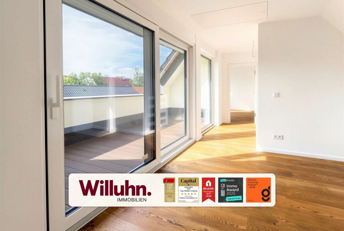 Bright modern living area with large sliding glass doors to a balcony and warm wood floor, with a Willuhn Immobilien banner at the bottom.