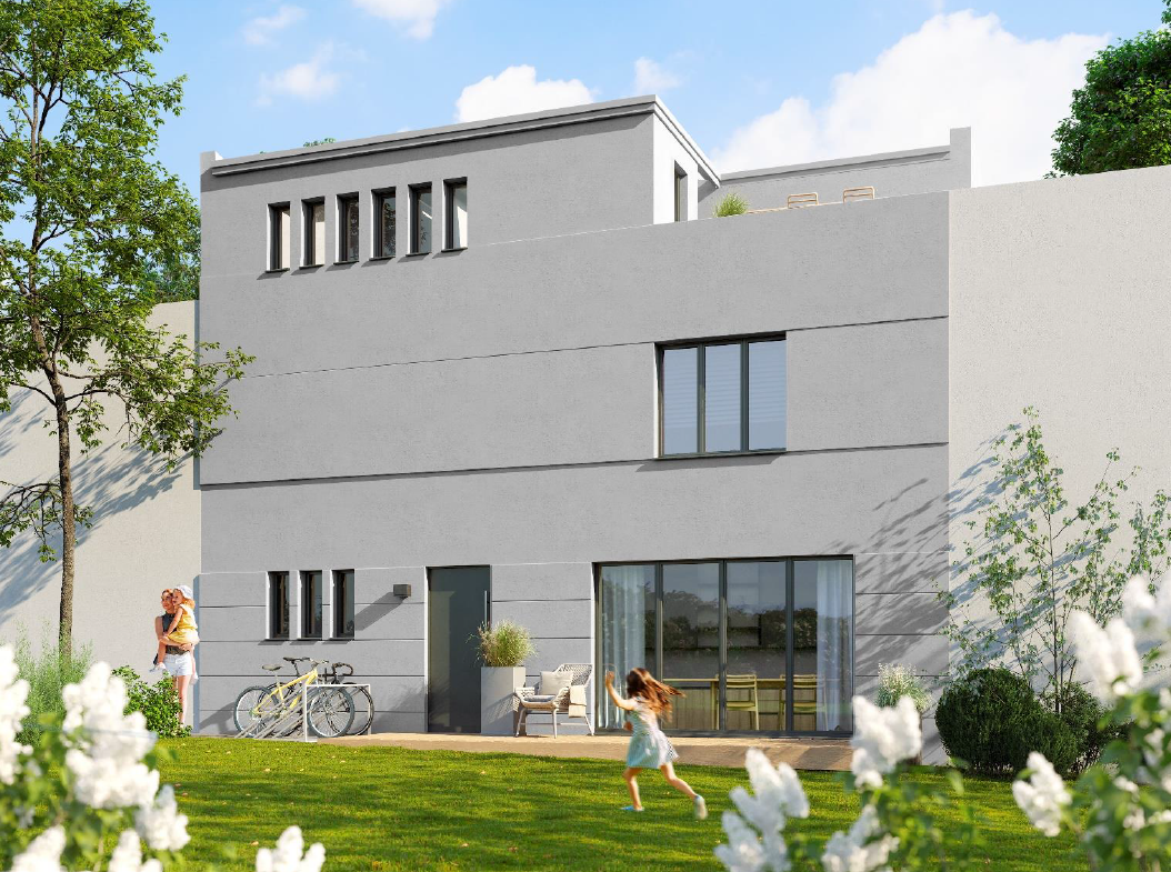 Modern gray two-story house with a patio and large sliding doors; a mother and child play in the sunny backyard with bicycles nearby.
