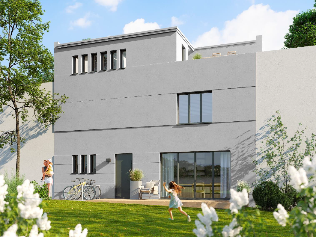 Modern gray two-story house with a patio and large sliding doors; a mother and child play in the sunny backyard with bicycles nearby.