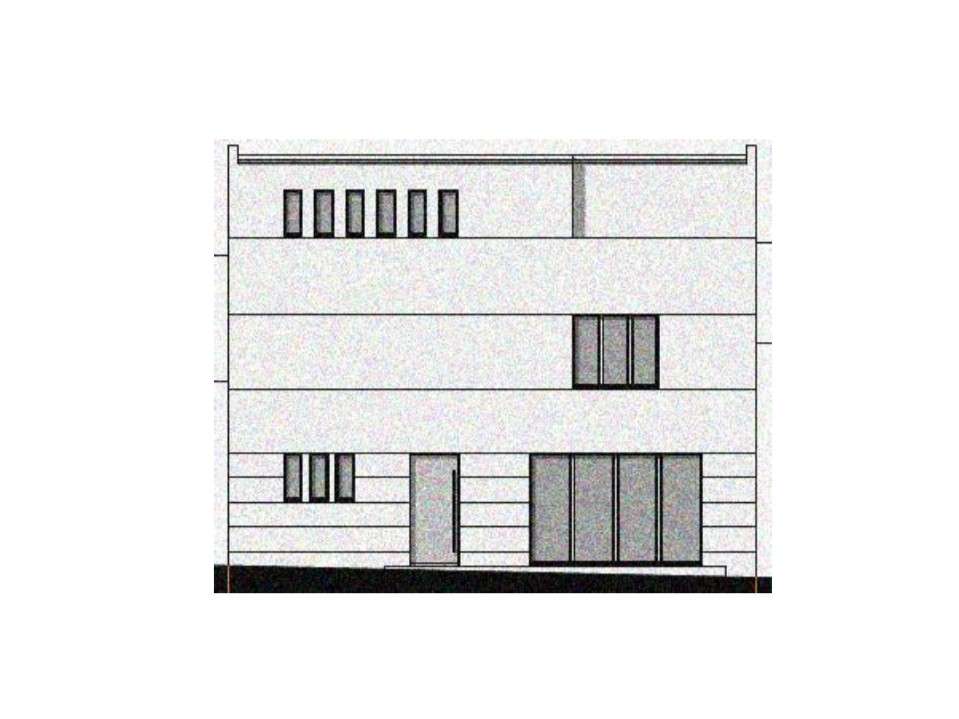 Three‑story modern building facade with horizontal bands, narrow left windows, a single ground-floor door, and a row of tall glass panels on the right side.