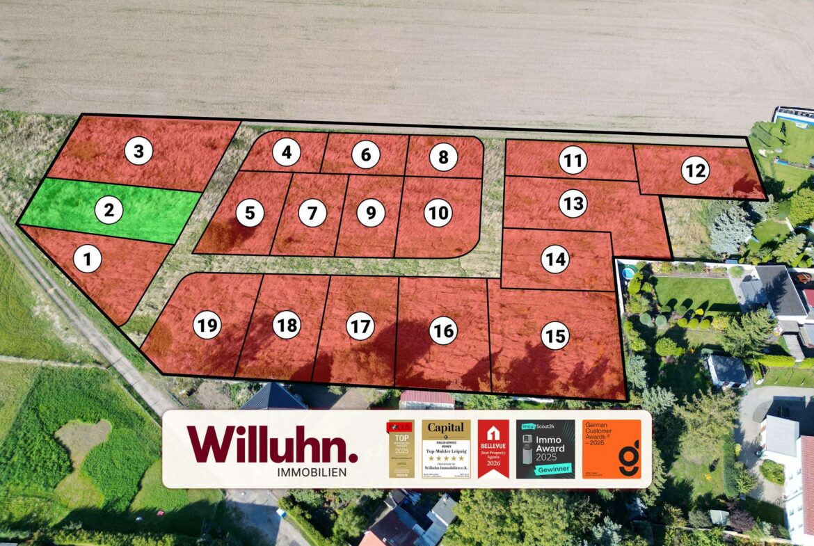 Aerial map of subdivision showing numbered red lots and one green lot (lot 2) ready for sale.