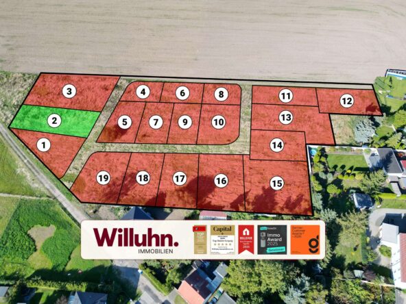 Aerial map of subdivision showing numbered red lots and one green lot (lot 2) ready for sale.