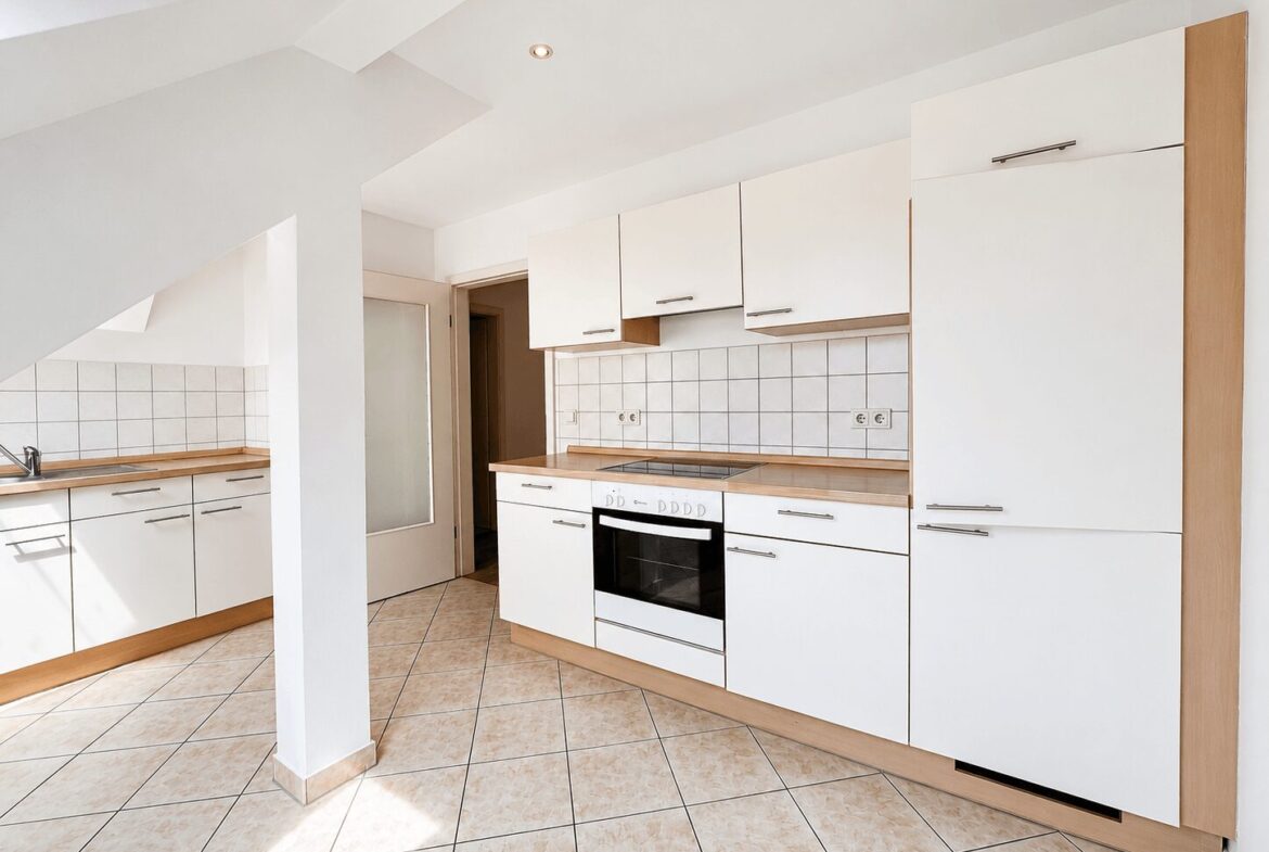 Bright white kitchen with wooden countertops, white cabinets, and a built-in oven along the wall on the right side.