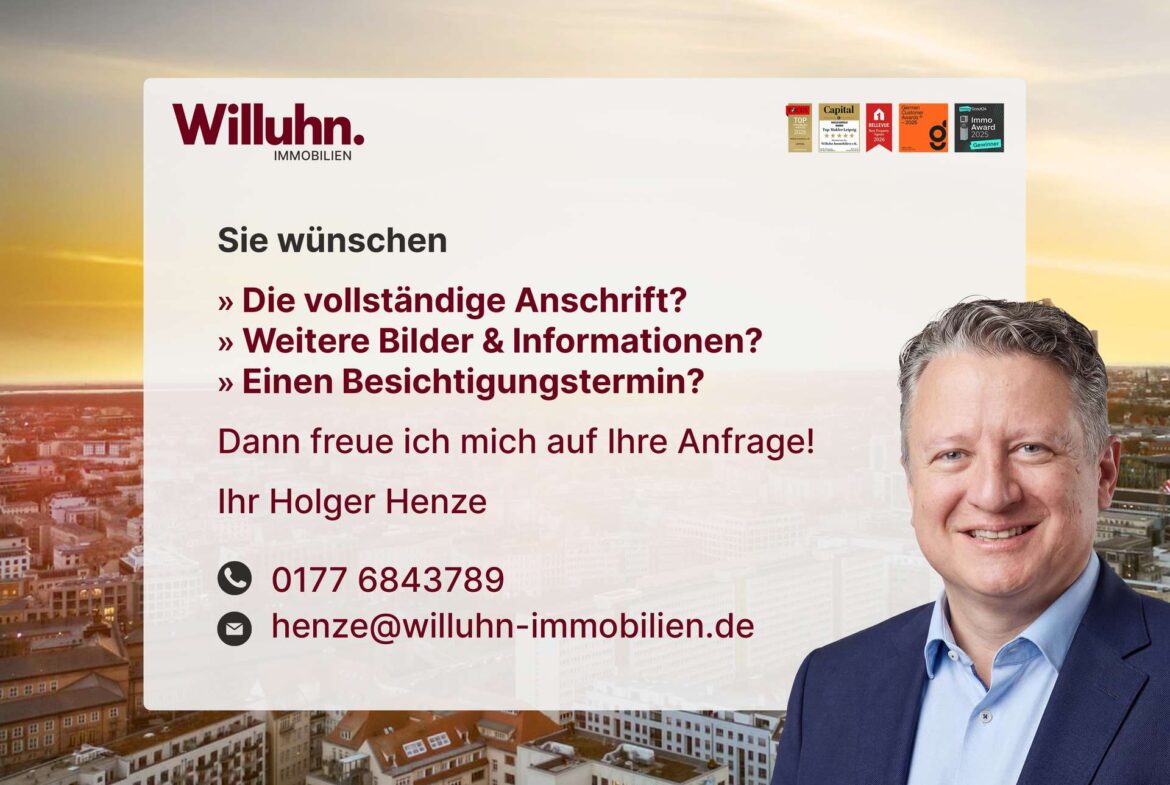 Willuhn Immobilien banner: smiling man in a suit on the right, bold red German text over a city skyline background with contact info on the left top.