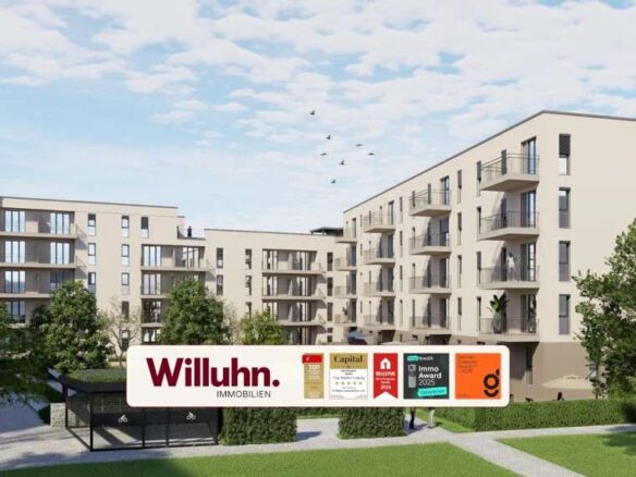 Modern beige apartment complex with multiple balconies and a grassy courtyard; foreground shows a large Willuhn Immobilien sign.