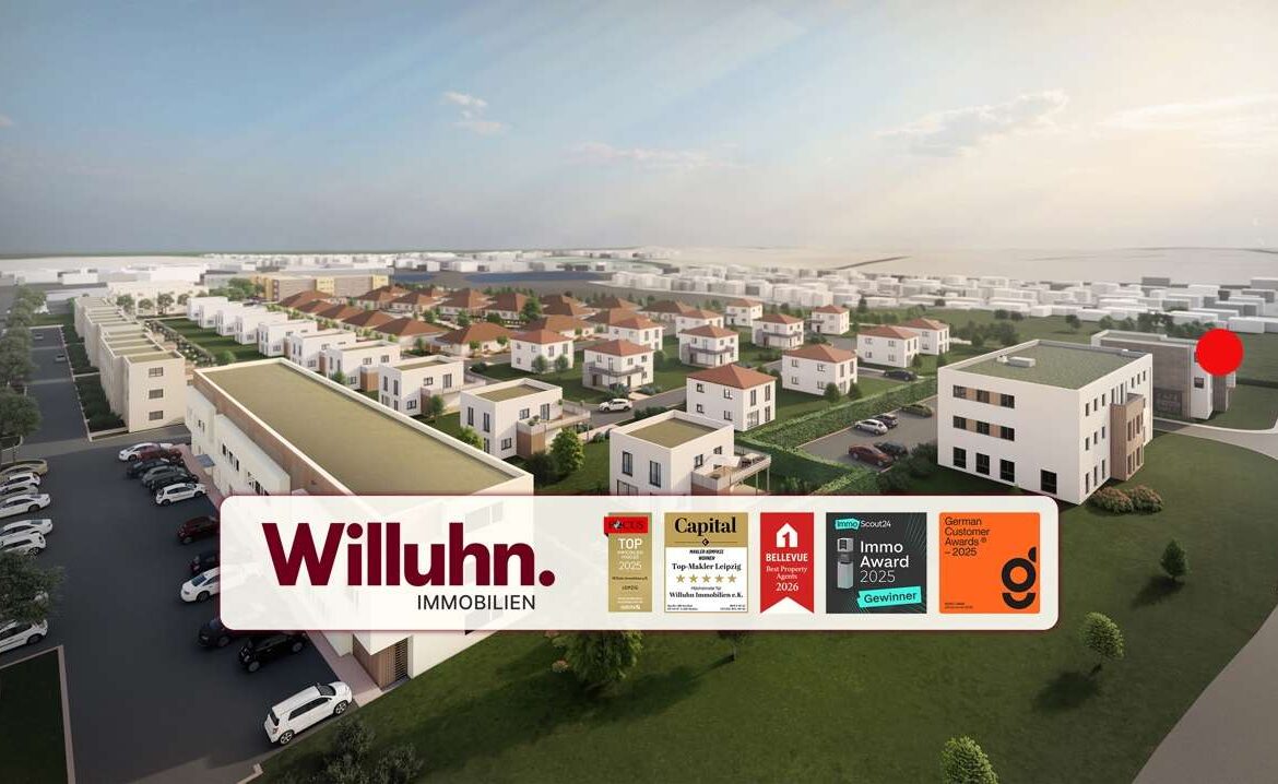 Aerial view of a suburban housing development with white modern homes and a large Willuhn Immobilien banner in the foreground with award badges nearby, sunny sky.