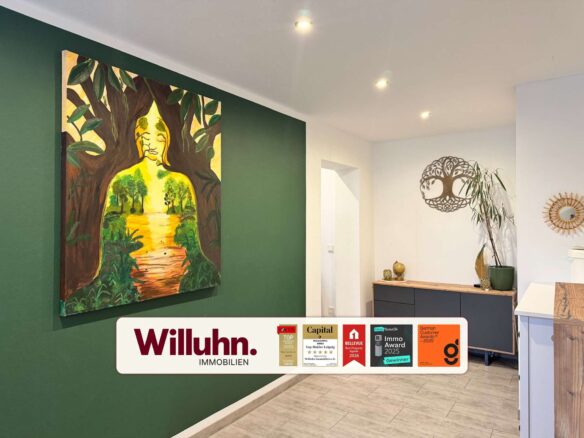 Interior showroom with a tall green accent wall and a large vibrant painting featuring a tree motif and a human silhouette beneath the branches.