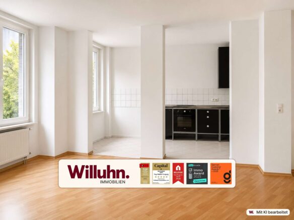 Bright, empty open-plan kitchen-living area with large windows, white walls, and light wood flooring.