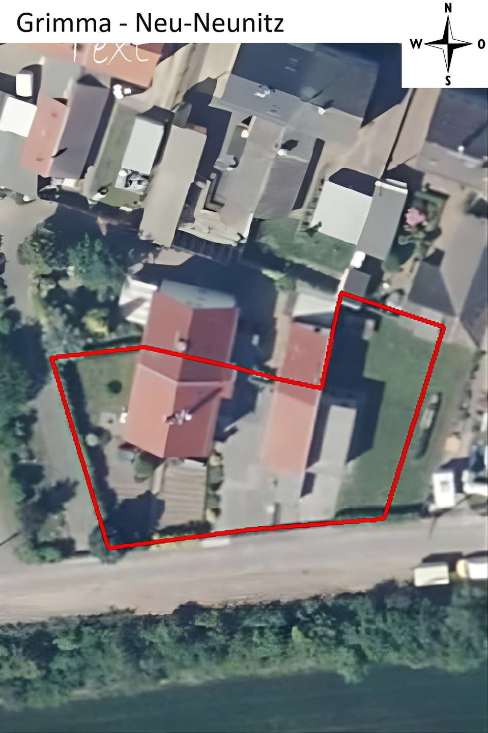 Aerial view of a residential area with a red boundary line outlining a lot that includes multiple buildings and a green lawn; a road runs along the bottom, with neighboring houses and trees visible, and a compass rose appears in the top-right corner.