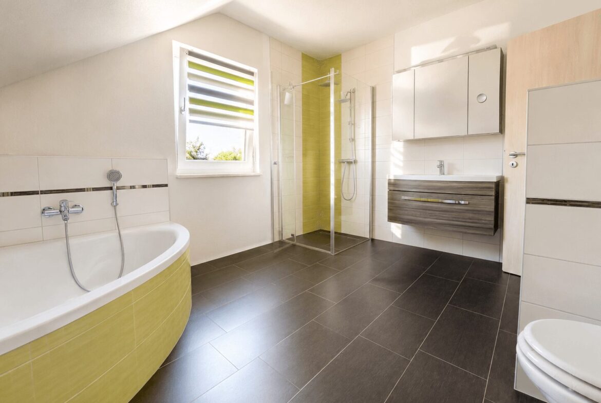 Modern bathroom with a corner bathtub, glass shower enclosure, and wall-mounted vanity with a wooden finish.
