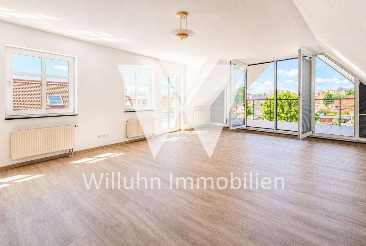 Bright empty living room with large glass doors to a balcony and a city view.