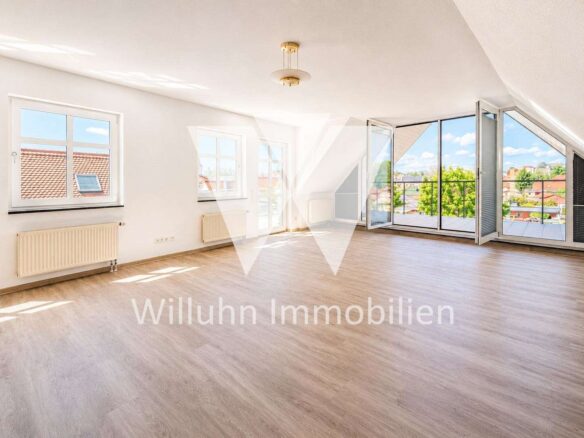 Bright empty living room with large glass doors to a balcony and a city view.