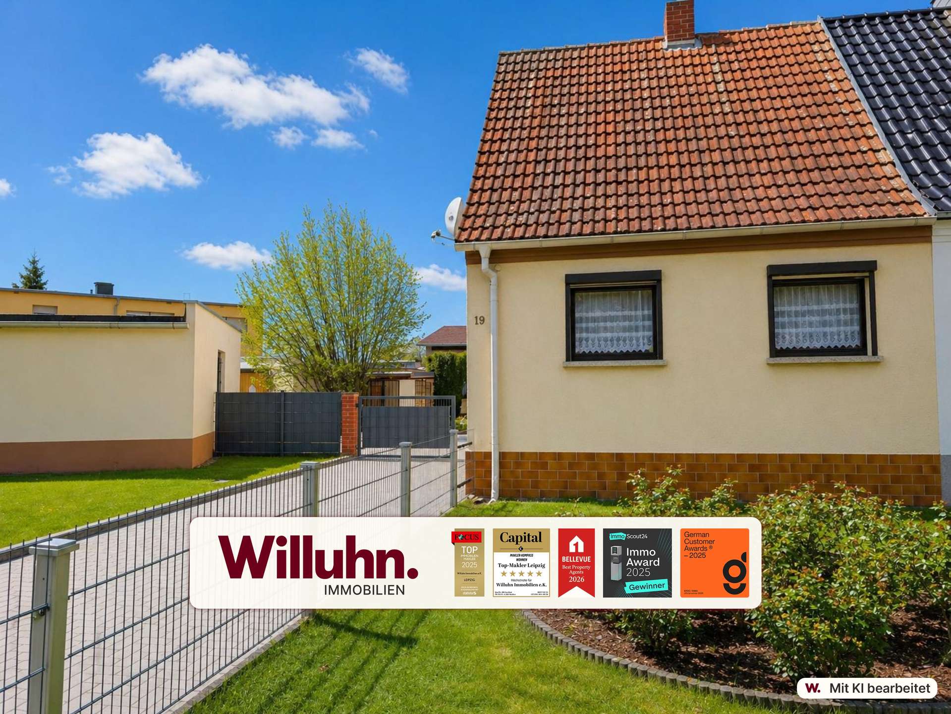 Residential property with red tiled roof, beige walls, and a Willuhn Immobilien sign in the front yard