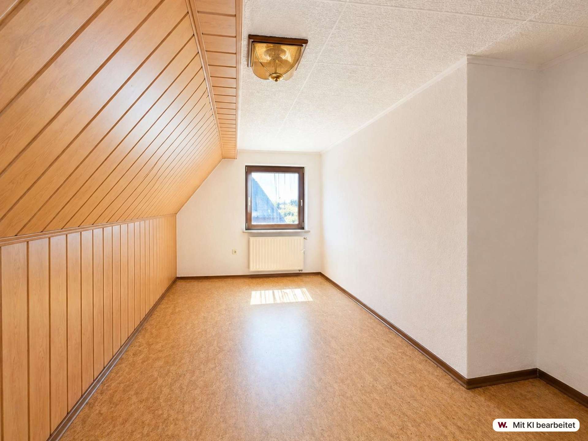 Narrow attic room with wooden paneled slanted wall on left, white walls, small window and radiator beneath it, empty space ahead.
