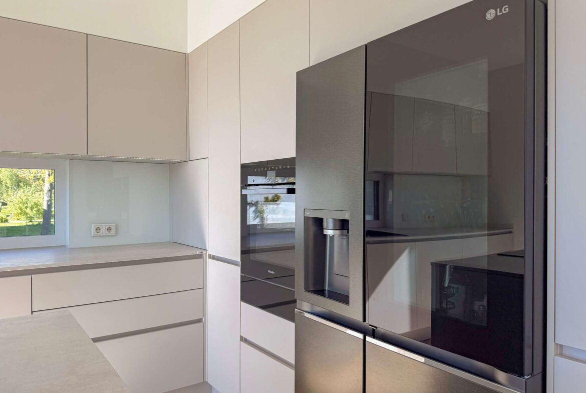 Modern kitchen with white cabinets and a large LG stainless steel refrigerator with a water/ice dispenser.