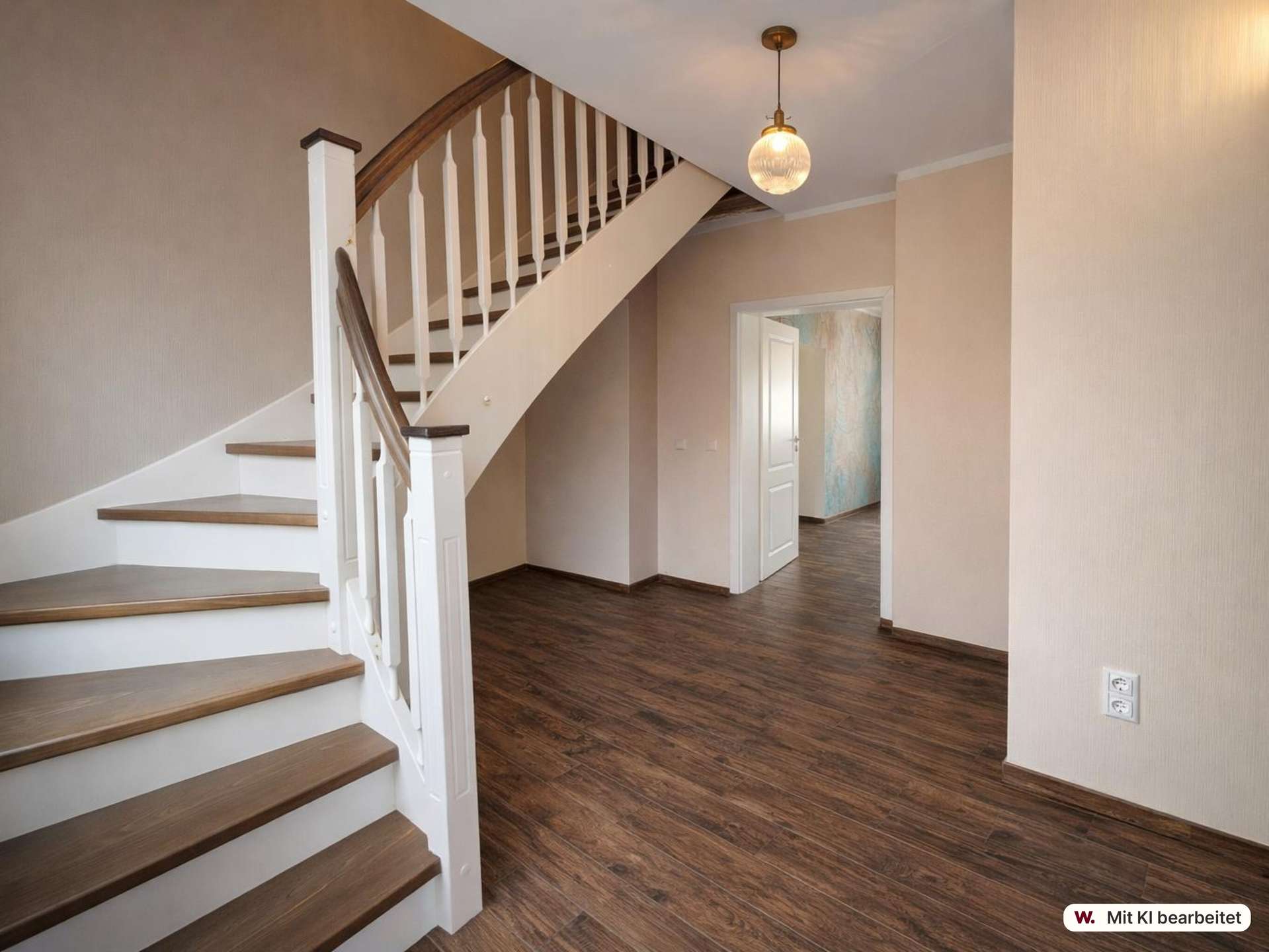 Foyer with dark wood floor, white staircase railing, and a hanging globe light above the staircase.