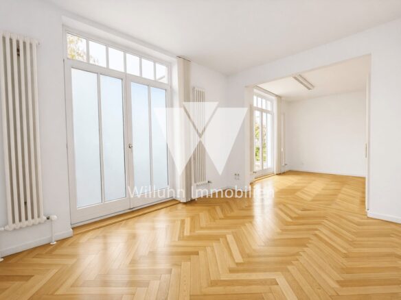 Bright, empty living room with white walls, herringbone parquet floors, tall radiators, and large glass doors to the outside patio/yard.