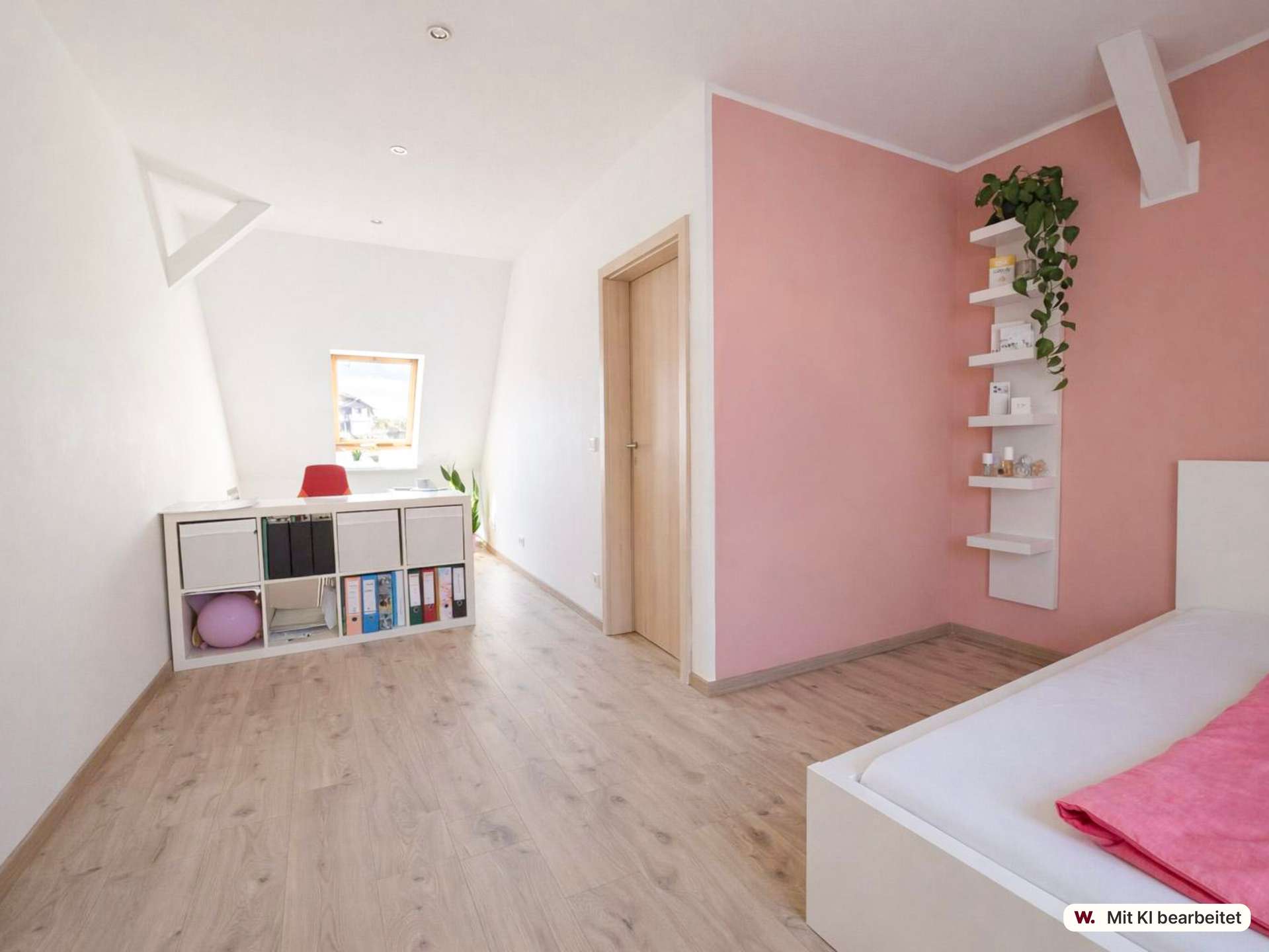 Bedroom with pink accent wall, white shelves and a low white bed visible at the edge, and a light wood floor.